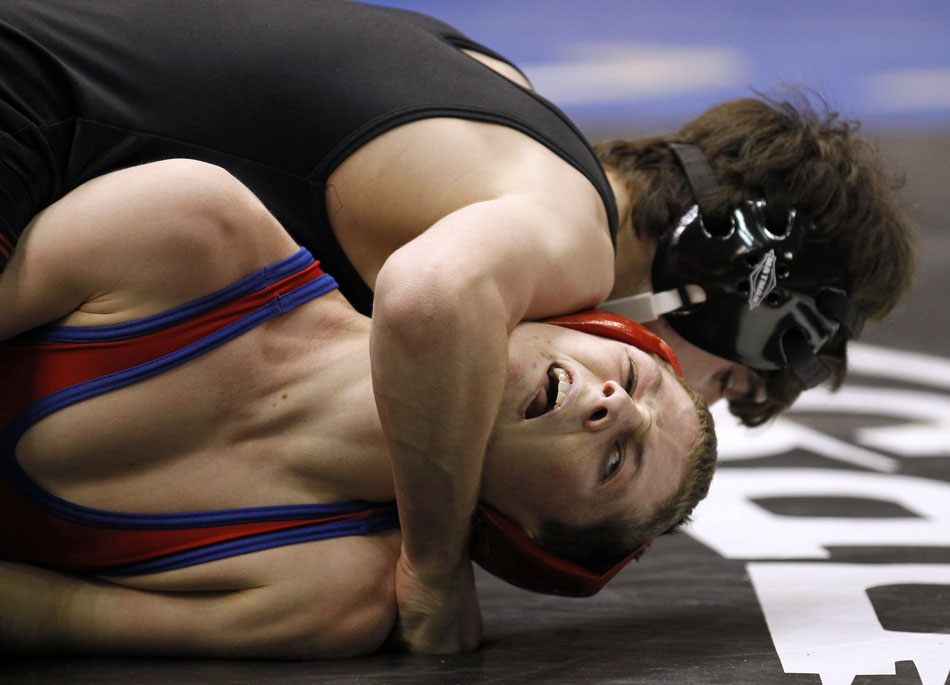 Evanston's Kyler Wagstaff reacts as Cheyenne Central's Alex Brown attempts to pin him during a Class 4A 119 pound matchup in the semi-final round of the Wyoming wrestling state finals on Friday, Feb. 25, 2011, in Casper, Wyo.