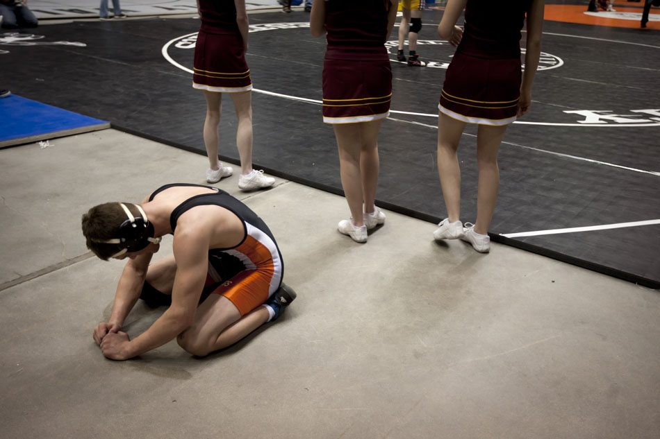 A Natrona County wrestler falls to his knees in tears after he was defeated in a state semi-final matchup on Friday, Feb. 25, 2011, in Casper, Wyo.