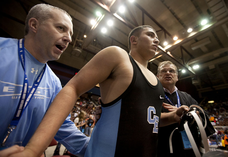 Cheyenne East's Michael Galicia gets some last-minute advice from his coaches as he walks onto the mat to take on Star Valley's Dawson Loveland during a semi-final match in the 4A 215 pound weight class on Friday, Feb. 25, 2011, in Casper, Wyo. Loveland won the match.