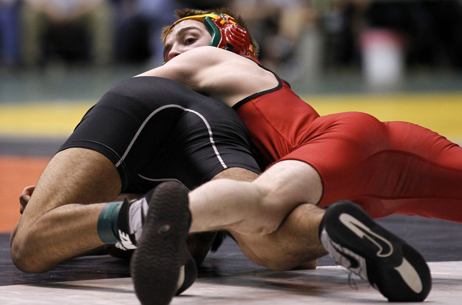 Rawlins' Austin Nicholson looks back at his coaches as he works to flip Cheyenne South's Joseph Romero during a wrestle back match in the Class 3A 135-pound bracket on Saturday, Feb. 26, 2011, in Casper, Wyo.