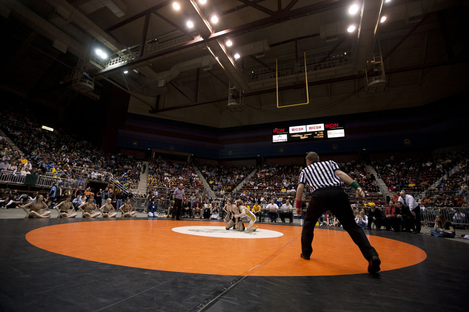 An official leans in to blow his whistle to re-start a Class 4A 103-pound finals match between Cheyenne Central's Bryce Meredith and Star Valley's Mitch Heap after Heap started bleeding during the Wyoming high school state wrestling tournament on Saturday, Feb. 26, 2011, in Casper, Wyo.