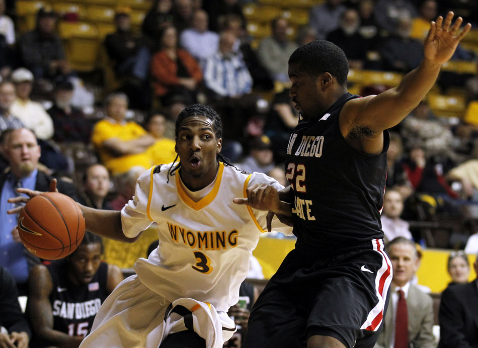 Wyoming guard Desmar Jackson (3) drives to the baseline and looks to go in for a shot as he's guarded by San Diego State guard Chase Tapley (22) during a NCAA men's basketball game on Tuesday, March 1, 2011, in Laramie, Wyo.