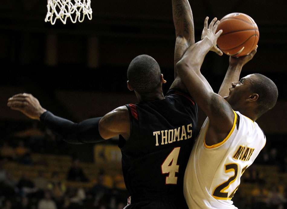 San Diego State forward Malcolm Thomas (4) attempts to block a shot from Wyoming forward Amath M'Baye (22) during a NCAA men's basketball game on Tuesday, March 1, 2011, in Laramie, Wyo.