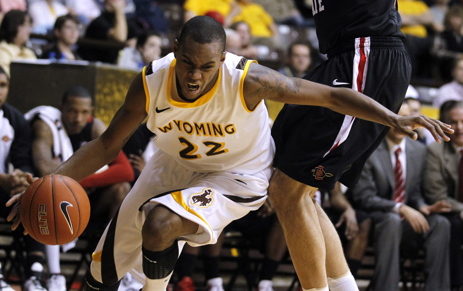 Wyoming forward Amath M'Baye (22) drives to the baseline in front of a San Diego State defender during a NCAA men's basketball game on Tuesday, March 1, 2011, in Laramie, Wyo.