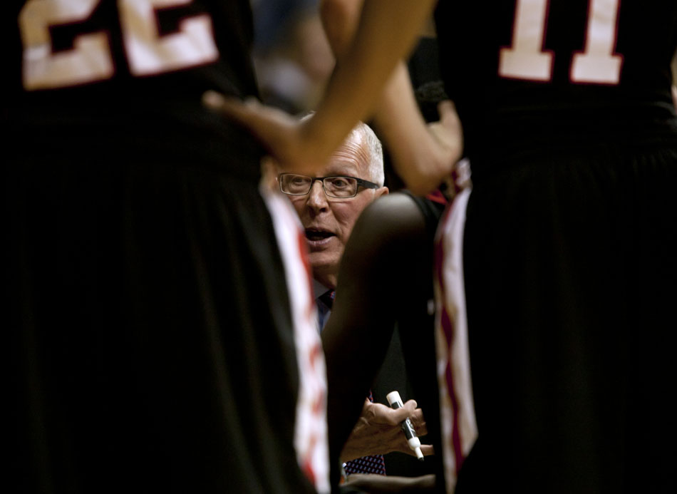 San Diego State coach Steve Fisher talks to his players in a huddle during a timeout in a NCAA men's basketball game against Wyoming on Tuesday, March 1, 2011, in Laramie, Wyo.