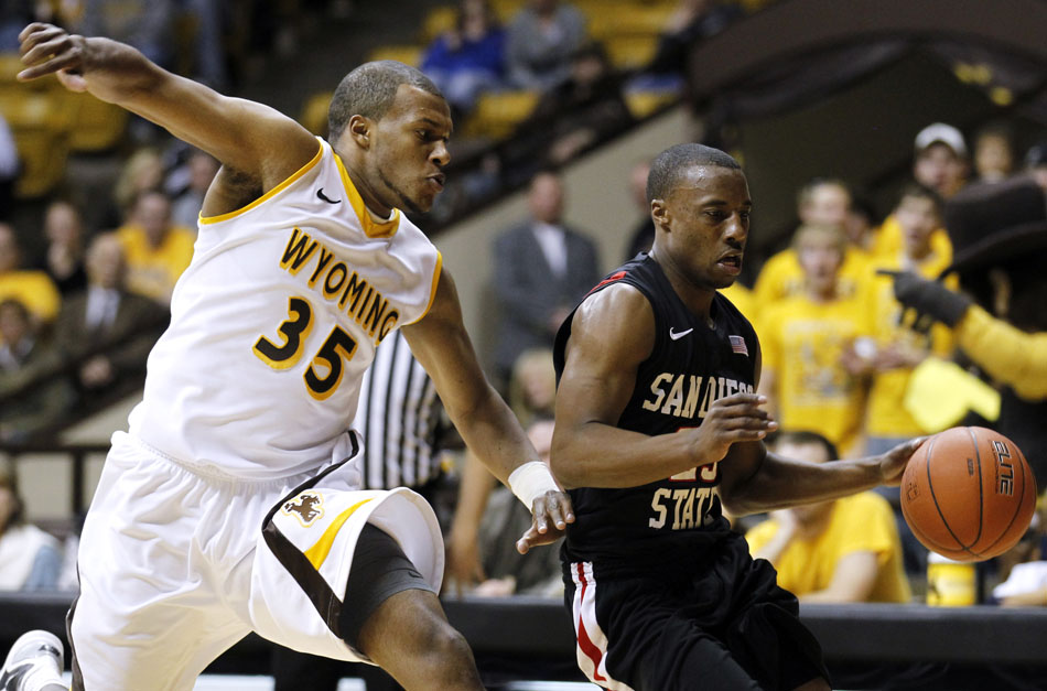 Wyoming guard/forward Daylen Harrison (35) looks to chase down San Diego State guard D.J. Gay (23) on defense during a NCAA men's basketball game on Tuesday, March 1, 2011, in Laramie, Wyo.