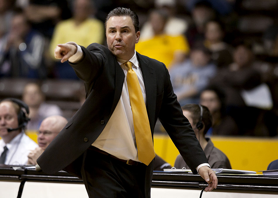 Wyoming interim coach Fred Langley instructs his players on offense during a NCAA men's basketball game on Tuesday, March 1, 2011, in Laramie, Wyo.
