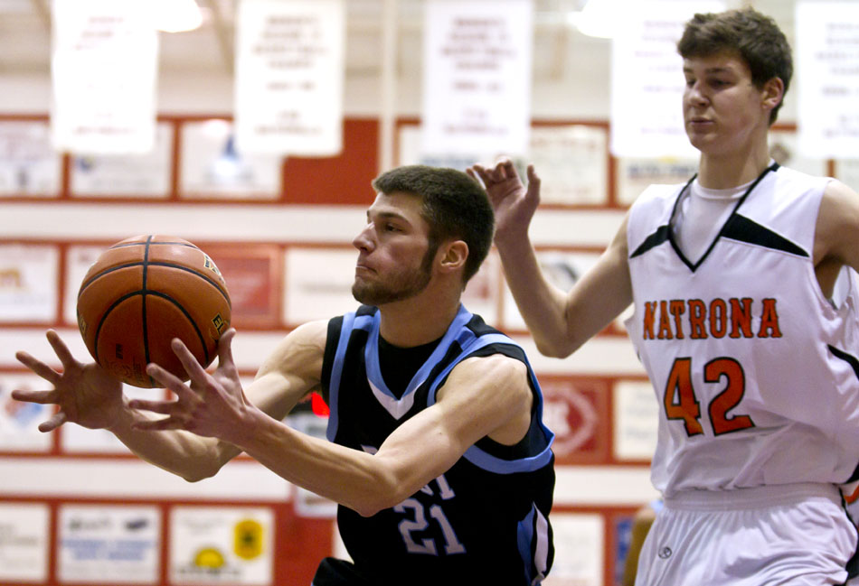 Cheyenne East's Cody Farrell (21) grabs a rebound in front of Natrona County's Andrew Martin (42) during a Class 4A boy's basketball state tournament game on Thursday, March 10, 2011, in Casper.