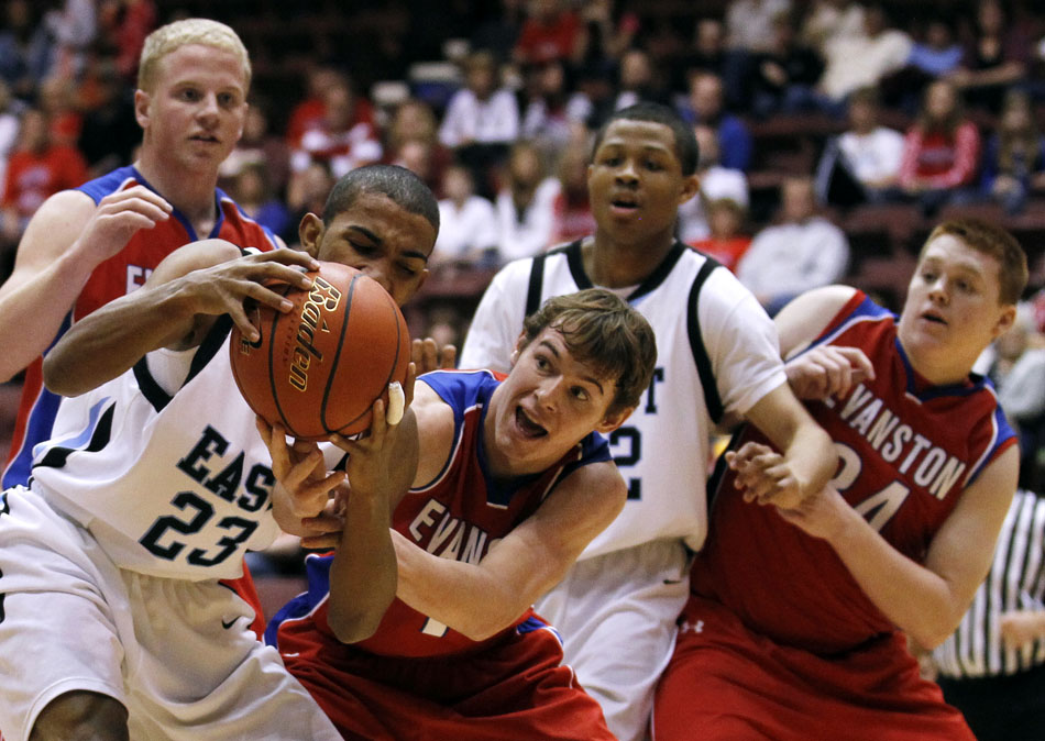 Evanston's Lance Barker tries to strip the ball away from Cheyenne East's Ramon Robinson during a Class 4A game in the state tournament fifth place bracket on Friday,  March 11, 2011, in Casper, Wyo.