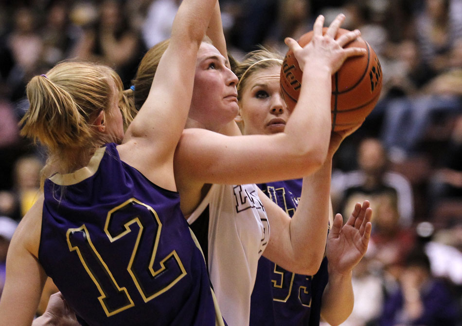 Laramie's Kensie Harris puts up a shot as she's defended by Gillette's Kari Borchgrevink (12) during a Class 4A girl's basketball semi-final on Friday, March 11, 2011, in Casper, Wyo.