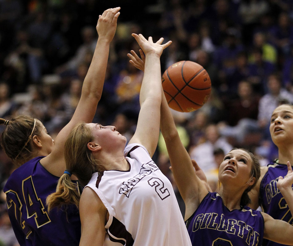 Laramie's Kensie Harris (2) reaches up for a rebound along with Gillette's Ashley Knofczynski (24) and Dani Williams (3) during a Class 4A girl's basketball semi-final on Friday, March 11, 2011, in Casper, Wyo.