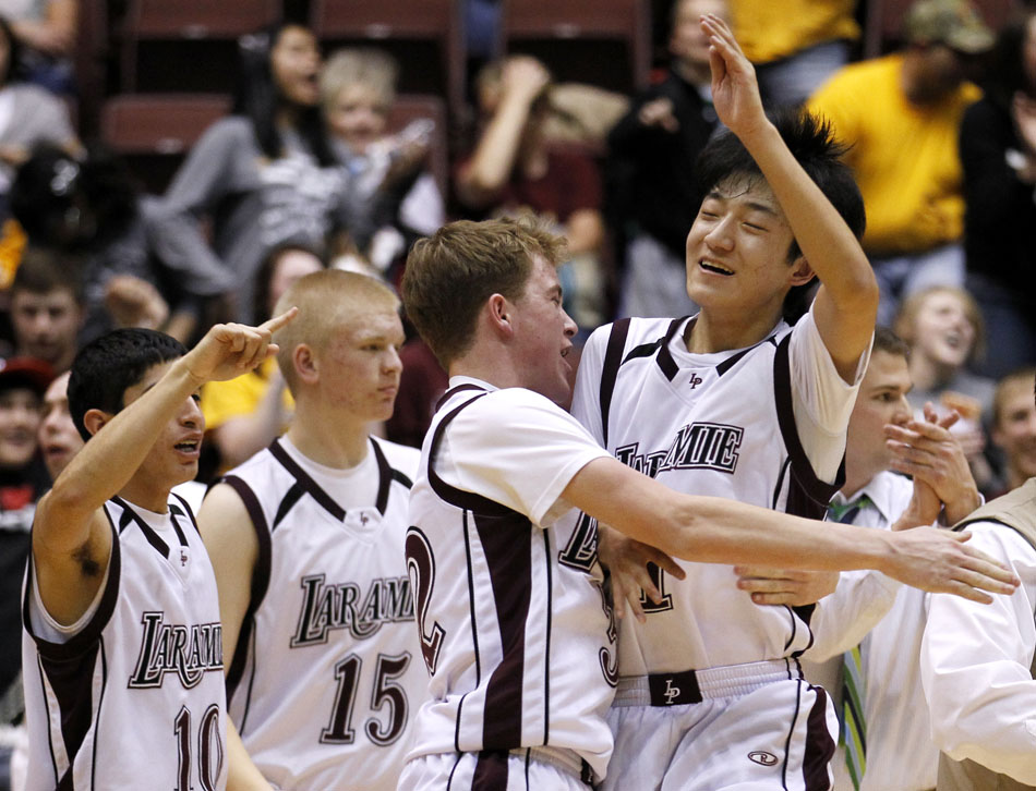Laramie's Steven Rahel celebrates with his teammates after a 61-56 win against Rock Springs in the Class 4A boy's basketball semi-final on Friday, March 11, 2011, in Casper, Wyo.