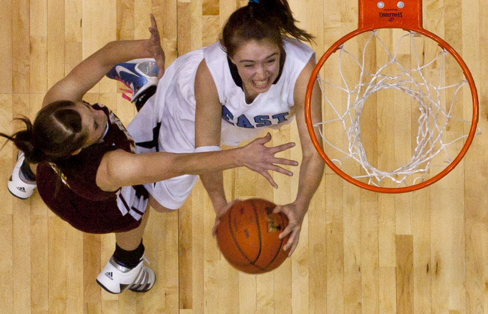 Cheyenne East's Savannah Minder goes in for a shot as she's guarded by Laramie's Shaley Anderson during a Class 4A girl's basketball consolation final on Saturday, March 12, 2011, in Casper, Wyo.