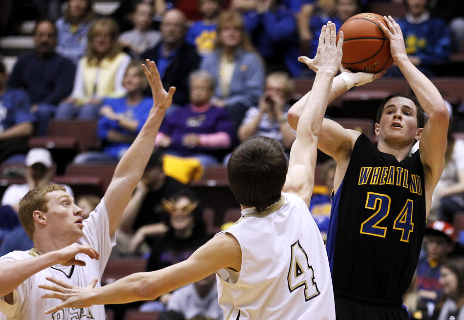 Wheatland's Ward Anderson (24) puts up a shot over Buffalo defenders during the Class 3A boy's basketball state championship game on Saturday, March 12, 2011, in Casper, Wyo.