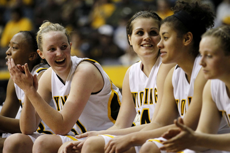 Wyoming forward Hillary Carlson, second from left, shares a laugh with her teammates as she watches a rout of Portland State in the first round of the WNIT game on Wednesday, March 16, 2011, in Laramie, Wyo.