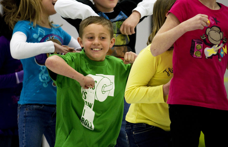 Aaron Money, a third-grader, dances along with some fellow students and a group of Africans during an acrobatics performance on Friday, March 18, 2011, at Freedom Elementary in Cheyenne.