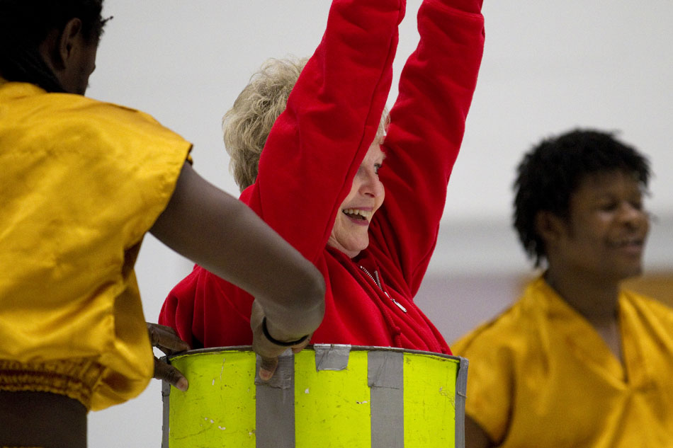 Principal Cindy Farwell reacts as a Keyan dancer slides her through a ring during a performance of African acrobatics on Friday, March 18, 2011, at Freedom Elementary in Cheyenne.