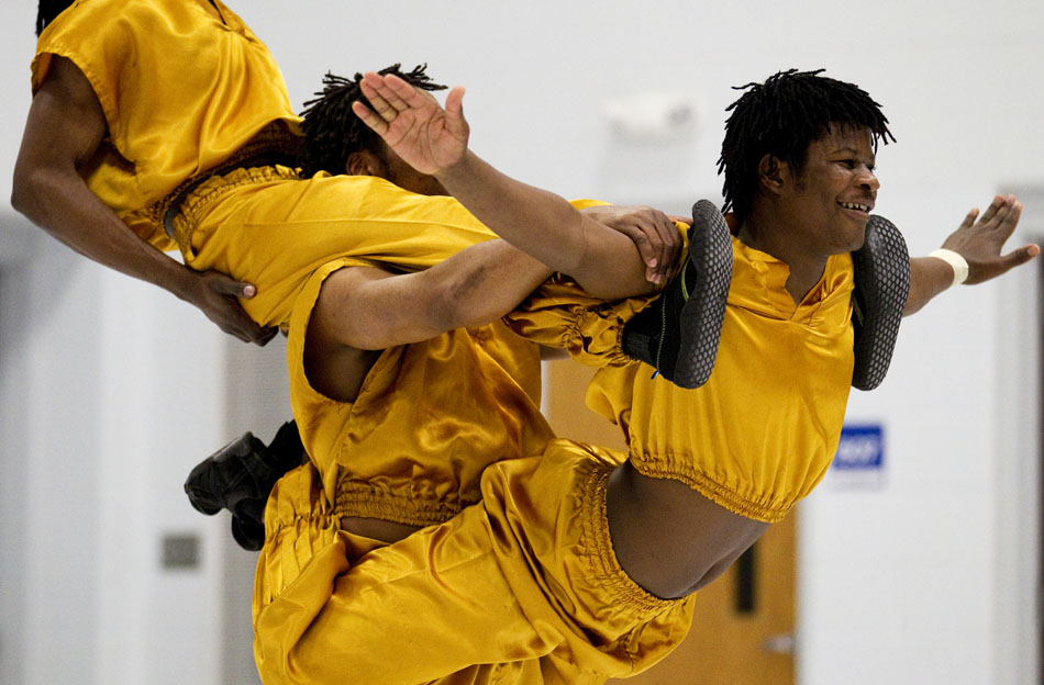 Lawrence Karrsa, right, smiles to the audience as he and his fellow Kenyans stack themselves up during a performance of African acrobatics on Friday, March 18, 2011, at Freedom Elementary in Cheyenne.