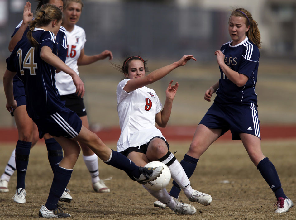 Cheyenne Central's Makena Cameron (9) slides in to deflect the ball away from Palmer Ridge's Ali Meyer (24) during a high school girl's soccer game on Saturday, March 19, 2011, at Cheyenne Central High School. Palmer Ridge won 3-2 in overtime.