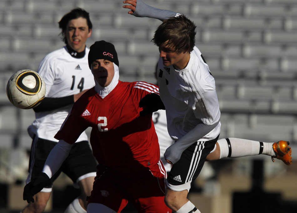 Cheyenne East's Clay Casey, right, clears the ball away from East's goal in front of Scottsbluff's Blade Miller (2) during a boy's soccer game on Tuesday, March 22, 2011, at Cheyenne East High School.