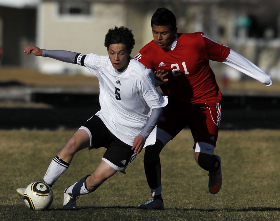 Cheyenne East's Jalen Willett (5) plays the ball past Scottsbluff's  Zack Vicharra (21) during a boy's soccer game on Tuesday, March 22, 2011, at Cheyenne East High School.