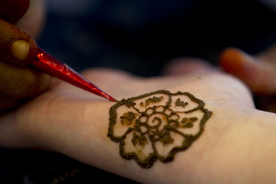 Silpa Kodru paints a henna tattoo on a teen's wrist on Wednesday, March 23, 2011, in the teen lounge at the Laramie County Library in Cheyenne.