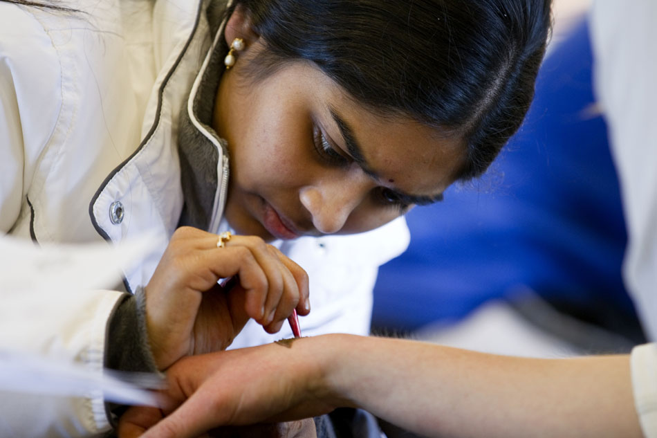 Silpa Kodru paints a henna tattoo on a teen's wrist on Wednesday, March 23, 2011, in the teen lounge at the Laramie County Library in Cheyenne.