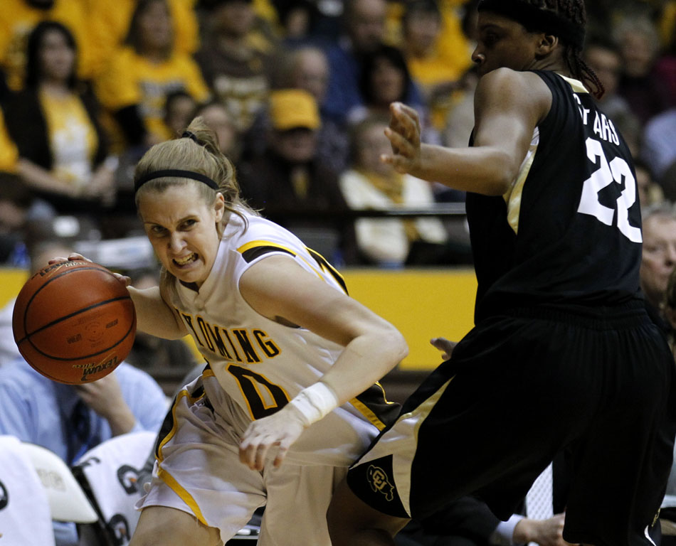 Wyoming's Bec Campigli (10) drives to the basket as she's guarded by Colorado's Brittany Spears (22) during a third round Women's NIT game on Thursday, March 24, 2011, in Laramie, Wyo.