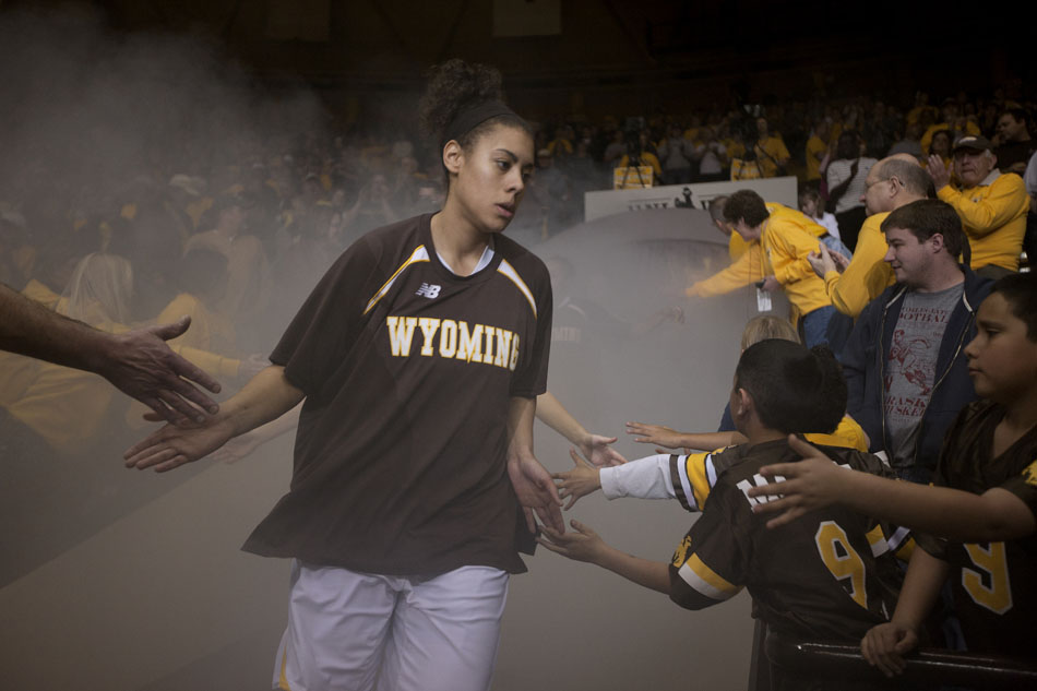Wyoming's Aubrey Vandiver slaps hands with fans as she enters the arena before a third round Women's NIT game on Thursday, March 24, 2011, in Laramie, Wyo.