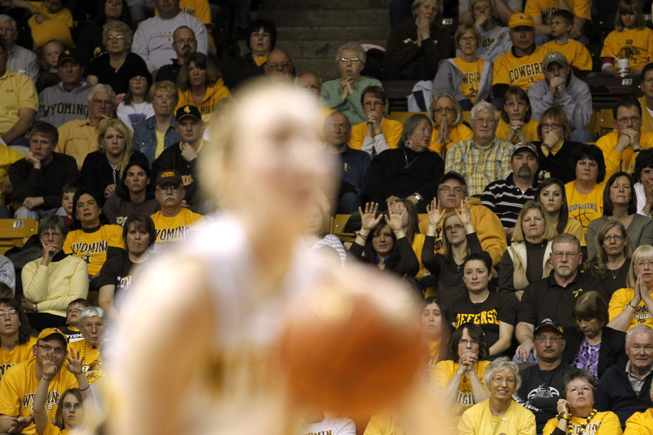 Fans watch as Wyoming's Hillary Carlson shoots a free throw during a third round Women's NIT game on Thursday, March 24, 2011, in Laramie, Wyo.