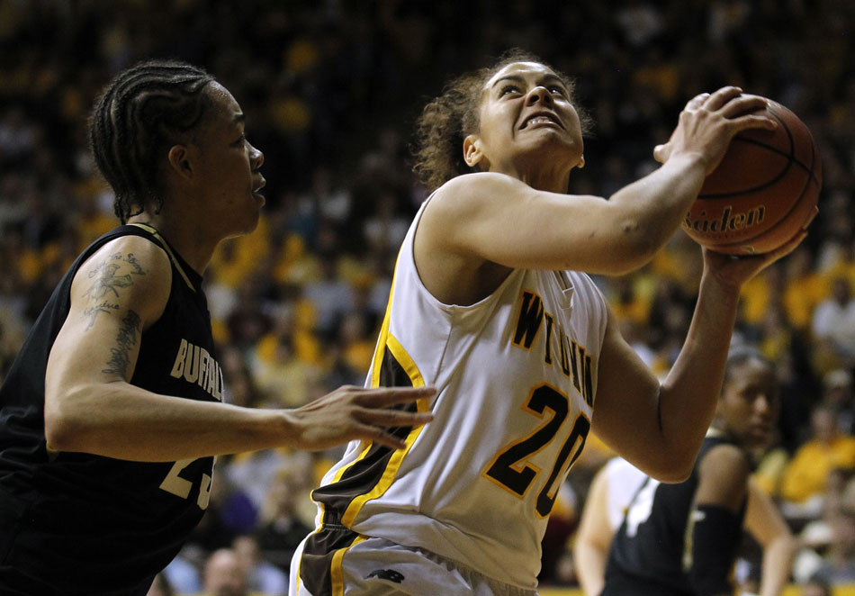 Wyoming's Aubrey Vandiver (20) goes in for a shot in front of Colorado's Chucky Jeffery (23) during a third round Women's NIT game on Thursday, March 24, 2011, in Laramie, Wyo.