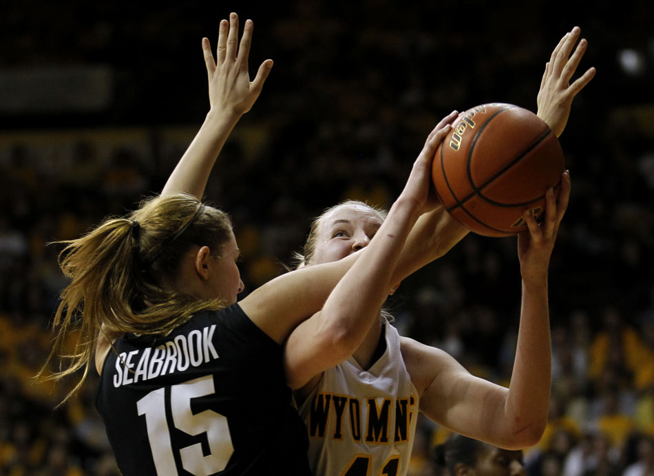 Wyoming's Hillary Carlson (41) puts up a shot against Colorado's Julie Seabrook (15) during a third round Women's NIT game on Thursday, March 24, 2011, in Laramie, Wyo.