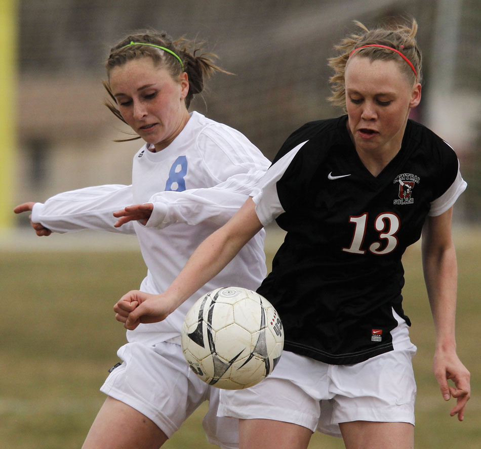 Cheyenne Central's Meghan Frank (13) plays the ball in front of Cheyenne East's Makenzie Drake (8) during a high school girl's soccer game on Friday, March 25, 2011, at Cheyenne East High School.