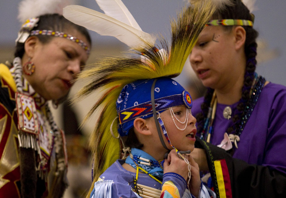 Jeremiah Wadena, age 12, gets a hand as he dresses during a traditional powwow held by the Southeast Wyoming Inter-Tribal Powwow Association (SEWIPA) on Saturday, March 26, 2011, at Laramie County Community College in Cheyenne.