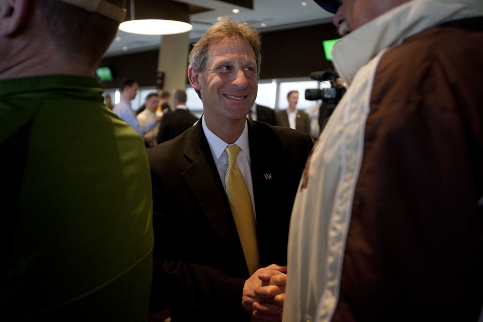 Wyoming basketball coach Larry Shyatt speaks with a fan after a press conference introducing him as the new Wyoming men's basketball coach on Wednesday, April 6, 2011, at the University of Wyoming in Laramie, Wyo. Shyatt, who was most recently an assistant coach at Florida, returns to head a program he coached for one season in 1997-1998 before leaving to coach at Clemson.