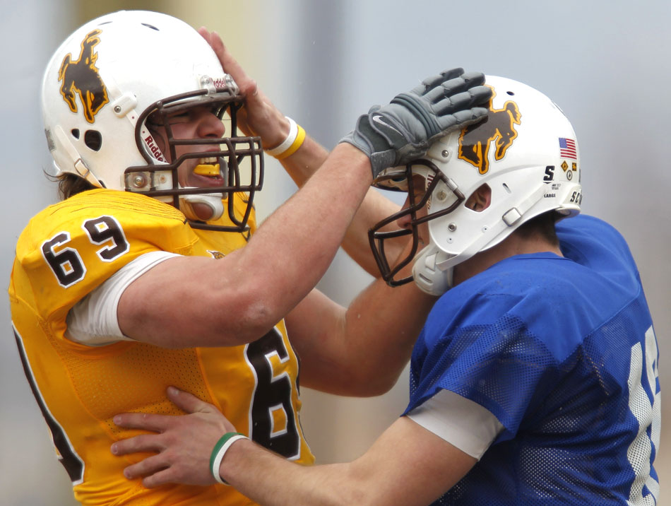 Wyoming quarterback Brett Smith, right, celebrates with tackle John Hutchins (69) after Smith scored on a quarterback sneak during Wyoming's Brown and Gold spring football game on Saturday, April 9, 2011, in Laramie, Wyo. Gold won 14-13.