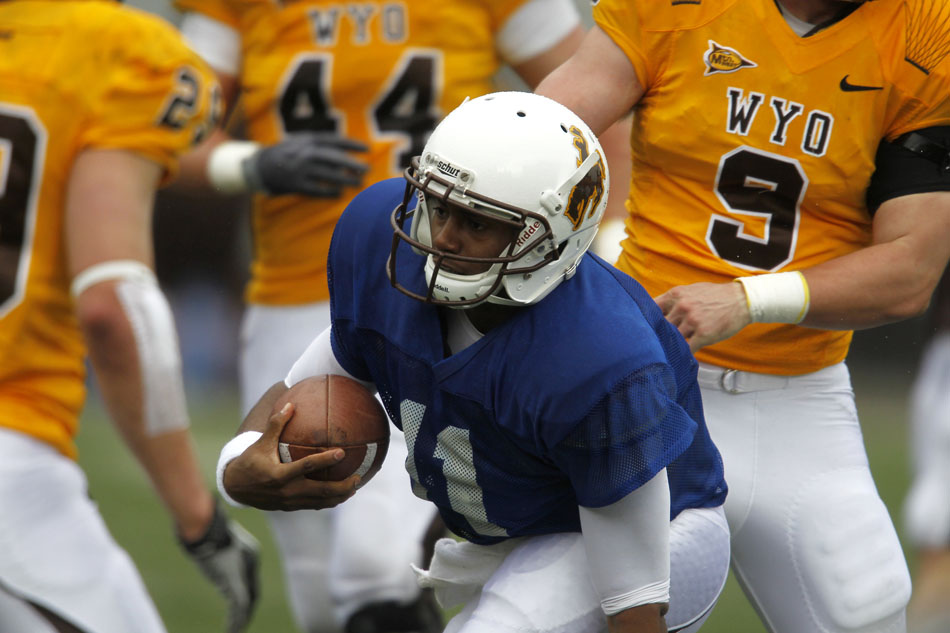 Wyoming quarterback Emory Miller Jr. (11) rushes the ball during Wyoming's Brown and Gold spring football game on Saturday, April 9, 2011, in Laramie, Wyo. Gold won 14-13.