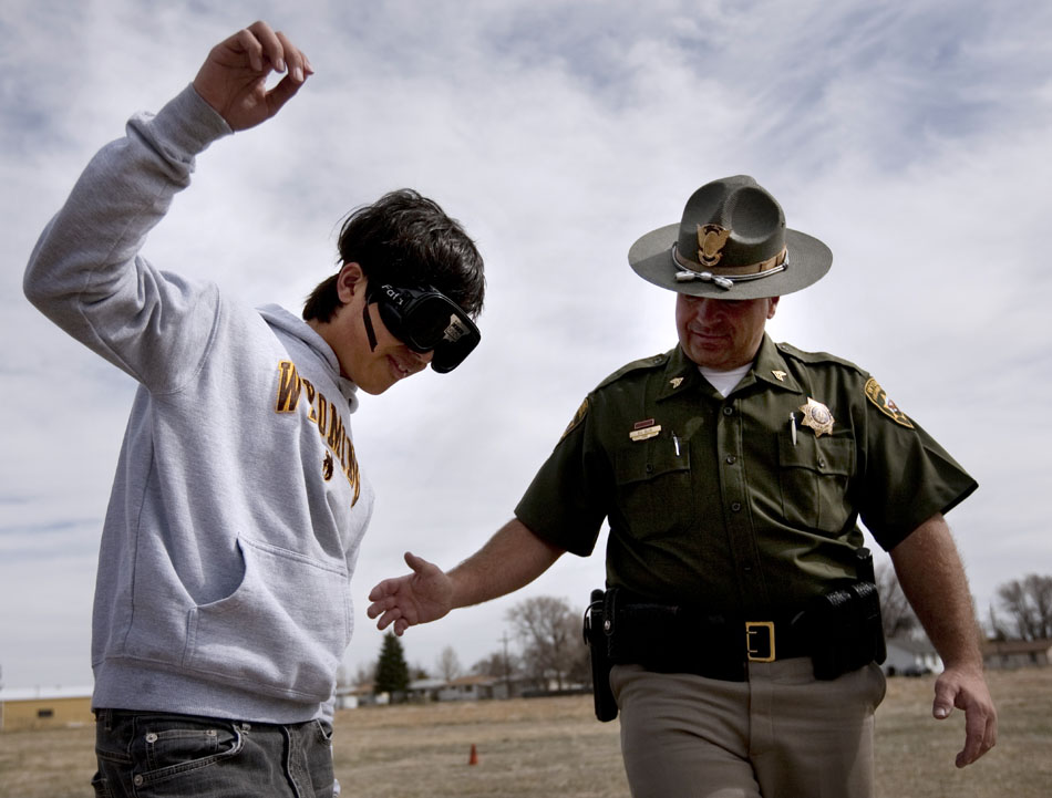 Wyoming Highway Patrol sergeant Duane Ellis, left, administers a sobriety test to Cheyenne East student Arthur Hsieh as Hsieh wears drunk goggles on Tuesday, April 12, 2011, at Cheyenne East High School. Troopers demonstrated the effects of drunk driving at the school as many students prepare for the prom on Saturday.