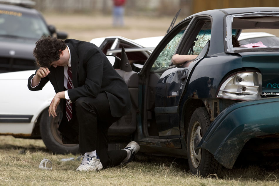 Cheyenne East student Jon Adams reacts after he stumbles out of a wrecked car during a drunken driving demonstration on Tuesday, April 12, 2011, at Okie Blanchard Stadium. The demonstration coincides with East's prom this Saturday.