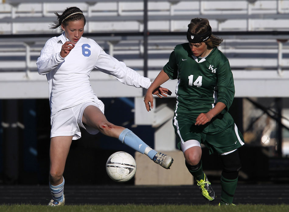 Cheyenne East's Rachel Erickson (6) plays the ball in front of Kelly Walshdefender April Taylor (14) during a high school girl's soccer game on Tuesday, April 19, 2011, at Cheyenne East High School.