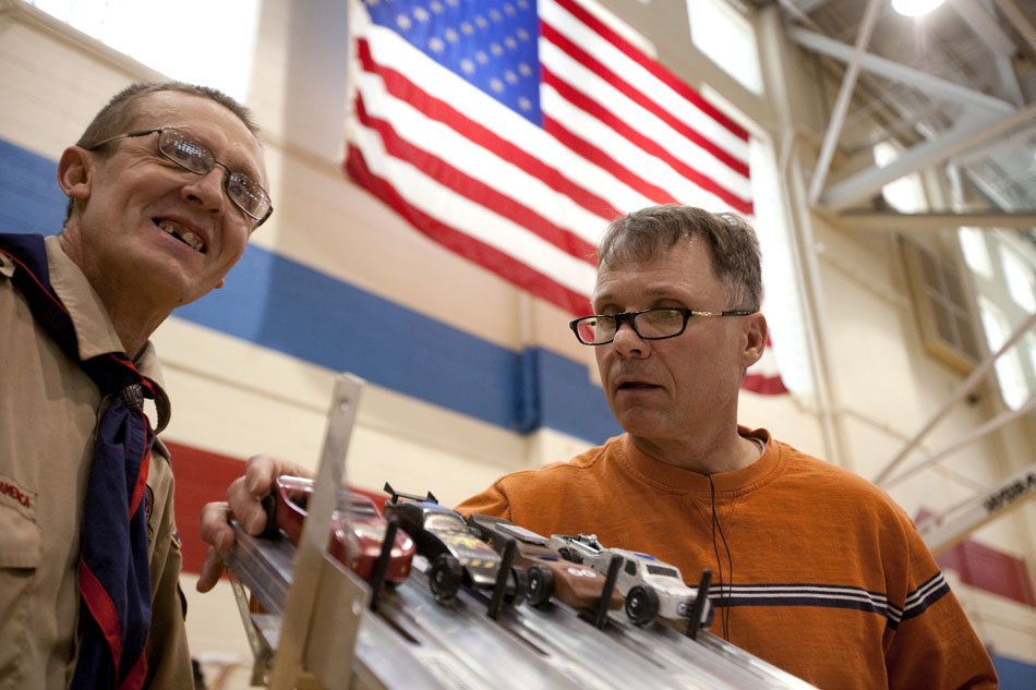 Volunteers prepare for a heat in the pinewood derby on Saturday, April 23, 2011, at Storey Gym.
