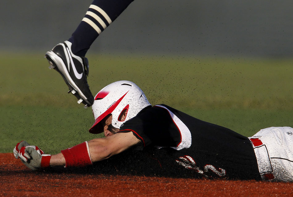 Gillette's Matt Fogle slides safely into second base as the leg of Cheyenne Post 6's Jordan Mossey almost hits him the face during a baseball game on Saturday, May 7, 2011, at Powers Field in Cheyenne.
