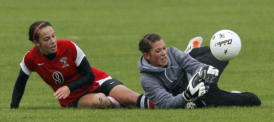 Cheyenne East keeper Shayne Carter, right, grabs the ball away from Cheyenne Central's Makena Cameron as Cameron slid in to kick the ball into the goal during a Class 4A girl's state soccer third place game on Saturday, May 21, 2011, in Sheridan, Wyo.