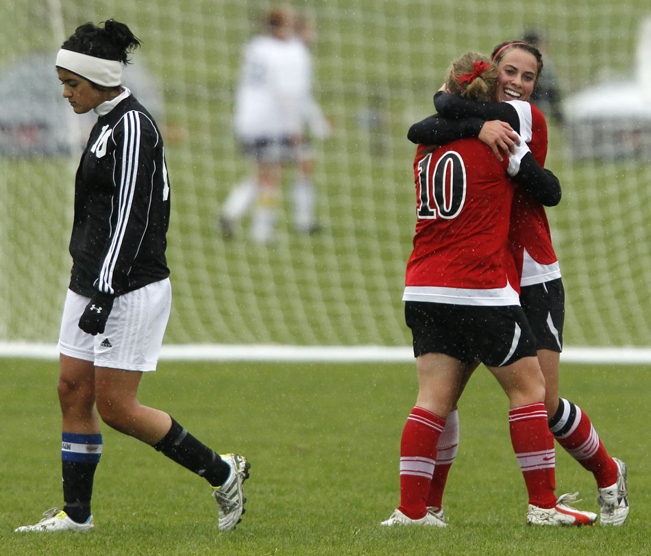 Cheyenne Central's Makena Cameron, right, hugs teammate Halee Moore (10) as Cheyenne East's Victoria Arenas walks back towards the bench following a goal from Cameron during a Class 4A girl's state soccer third place game on Saturday, May 21, 2011, in Sheridan, Wyo.