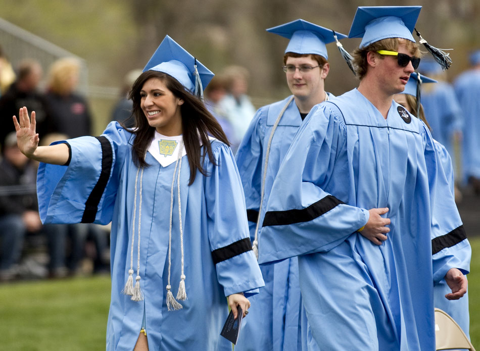A graduate waves to the crowd during Cheyenne's East High School graduation on Saturday, May 28, 2011, at Okie Blanchard Stadium.
