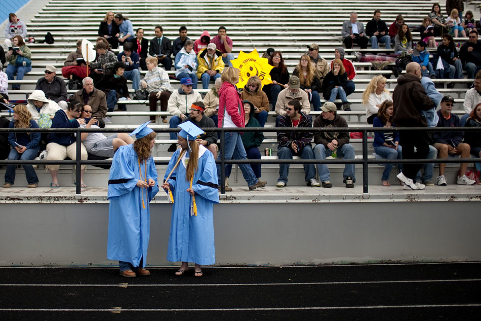 Two students compare their honor cords before Cheyenne's East High School graduation on Saturday, May 28, 2011, at Okie Blanchard Stadium.