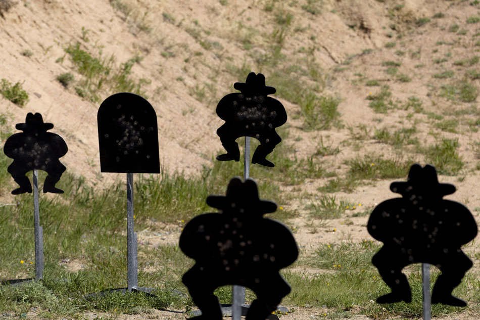 Metal targets depicting cowboys and tombstones stand pitted by gunfire on Saturday, June 4, 2011, at the Cheyenne Regulators Range west of Cheyenne.