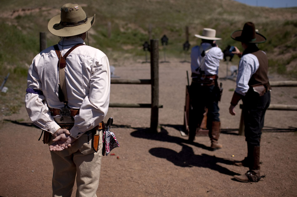 A cowboy counts hits on target as a fellow Cheyenne Regulators member competes in a cowboy shoot on Saturday, June 4, 2011, at the group's firing range west of Cheyenne.