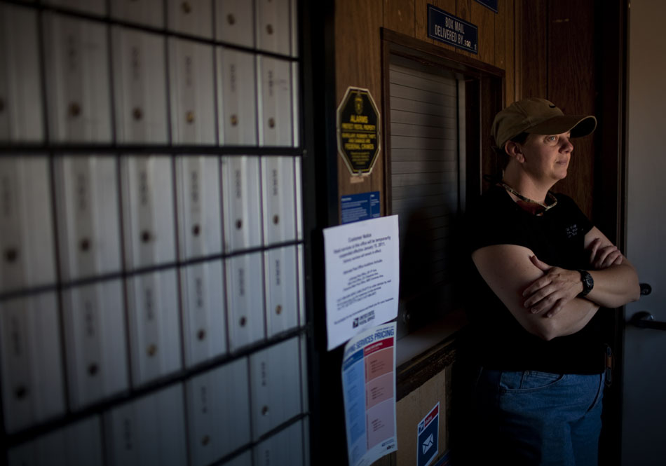 Kodilyn Krakow, a contracted mail carrier at the Meriden, Wyo. post office, waits by the door for a delivery of mail from the Cheyenne post office on Friday, June 10, 2011. The United States Postal Service is considering closing the Meriden post office, which houses about 30 post office boxes for residents of the rural community in northern Laramie County.