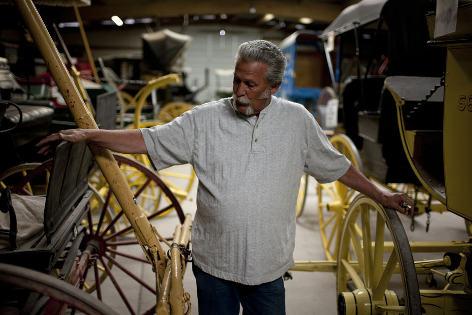 Tom Watson, the head wagon doctor, stands in the middle of several antique wagons in the shop on Friday, June 17, 2011, at Frontier Park. Watson has been a wagon doctor for 23 years. The wagon doctors restore and maintain antique wagons that are used in the Cheyenne Frontier Days parade each year.